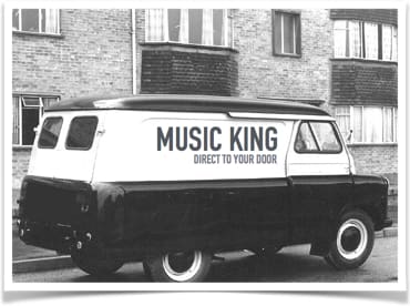 a white and black truck parked in front of a building